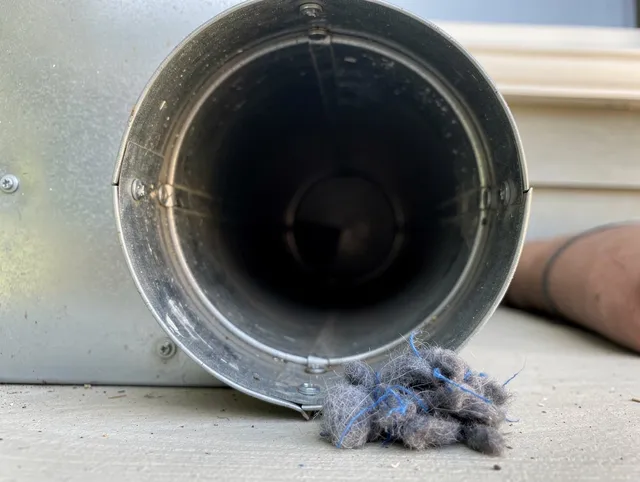 Norco Dryer Vent Cleaning technician using specialized equipment to clear severe dryer vent blockage in Norco